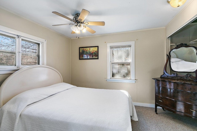 bedroom with multiple windows, crown molding, carpet flooring, and ceiling fan