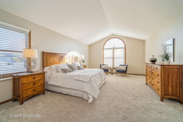 carpeted bedroom featuring lofted ceiling