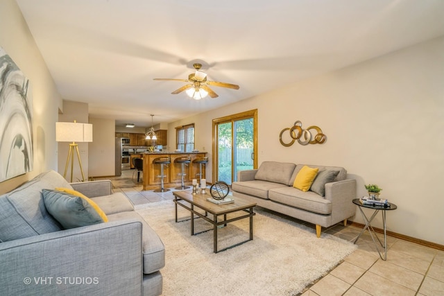 tiled living room featuring ceiling fan