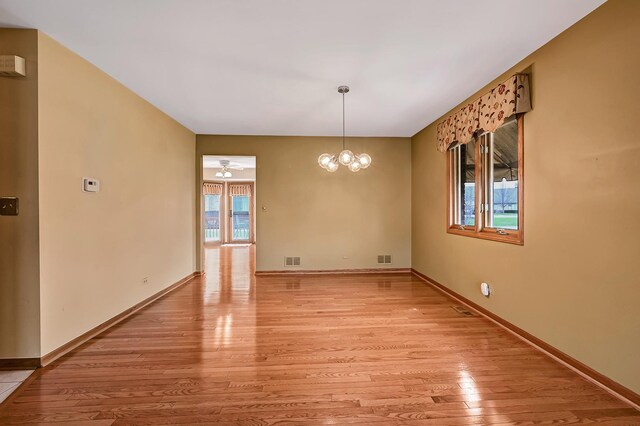unfurnished dining area featuring baseboards, visible vents, ceiling fan, and light wood-style floors