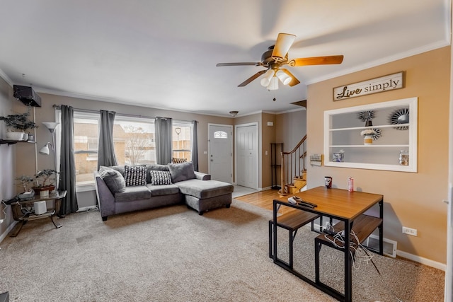 carpeted living room featuring crown molding and ceiling fan