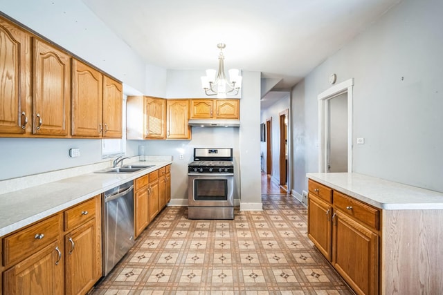 kitchen featuring pendant lighting, sink, a chandelier, and appliances with stainless steel finishes