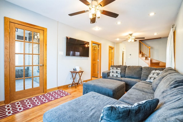 living room featuring light hardwood / wood-style flooring and ceiling fan