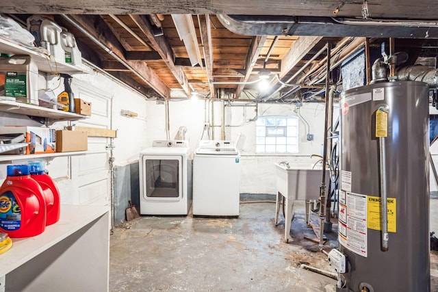 basement featuring water heater, separate washer and dryer, and sink