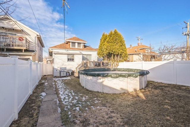 back of house with a covered pool