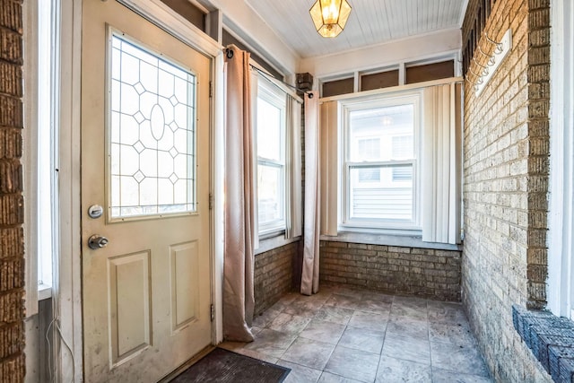 doorway to outside with brick wall