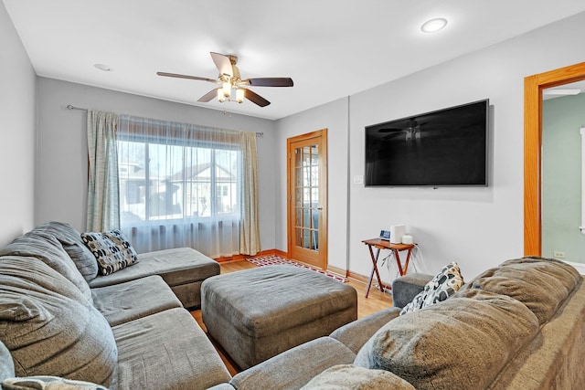 living room featuring hardwood / wood-style flooring and ceiling fan