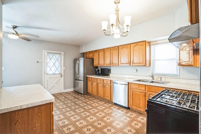 kitchen with sink, ceiling fan with notable chandelier, hanging light fixtures, and appliances with stainless steel finishes