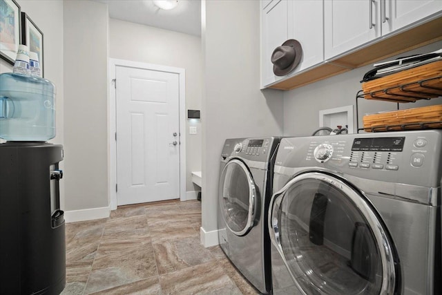 washroom featuring independent washer and dryer and cabinets