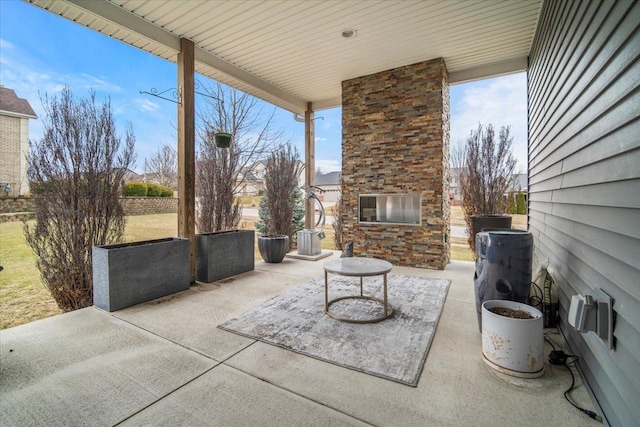 view of patio featuring a large fireplace