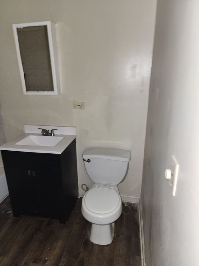 bathroom featuring vanity, toilet, and hardwood / wood-style floors