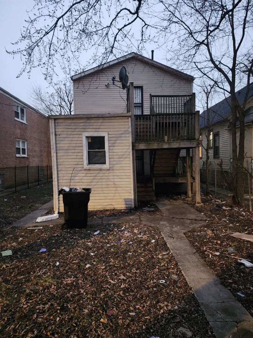 rear view of property featuring a deck