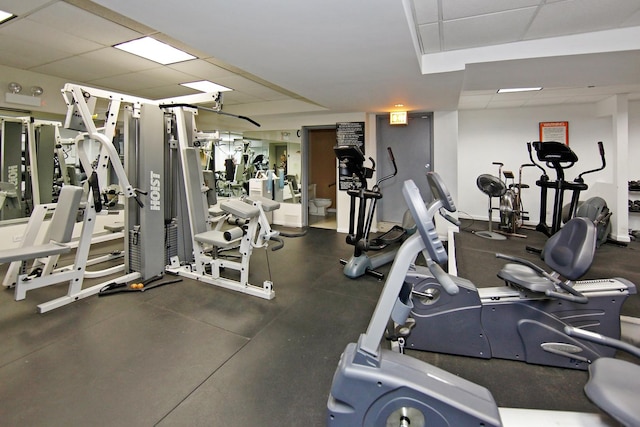 gym with a paneled ceiling