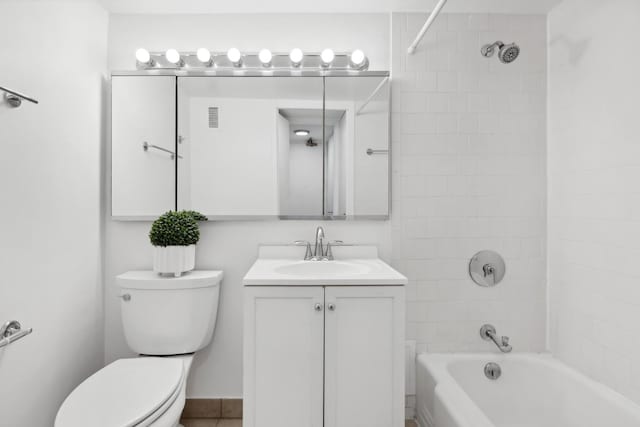 full bathroom with tiled shower / bath, vanity, and toilet