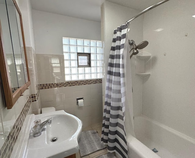 full bathroom with shower / tub combo, tile patterned flooring, tile walls, and vanity