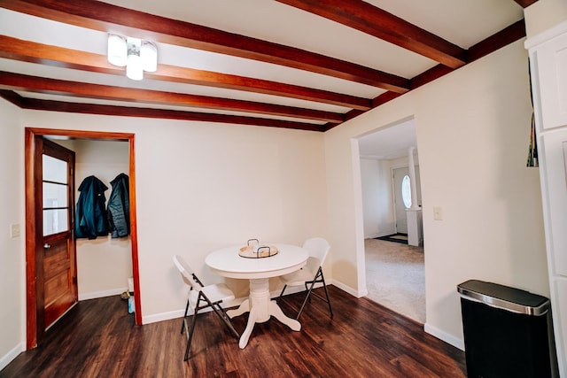 dining space featuring dark hardwood / wood-style floors and beam ceiling