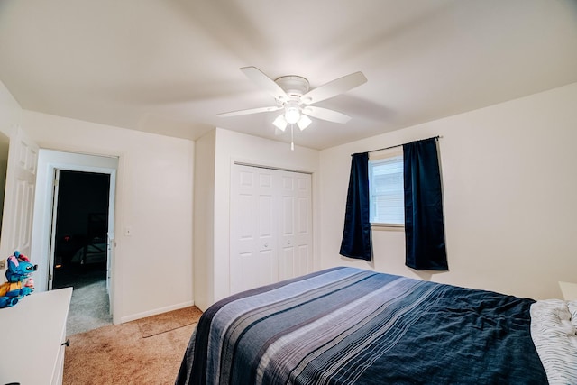 carpeted bedroom featuring ceiling fan and a closet