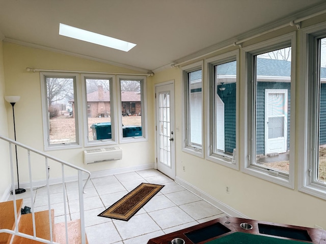 sunroom / solarium with vaulted ceiling with skylight, a wealth of natural light, and a wall unit AC