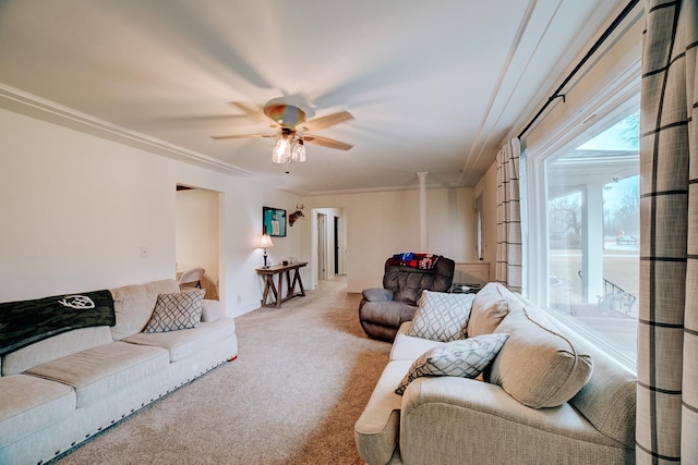 carpeted living room with ceiling fan and ornamental molding