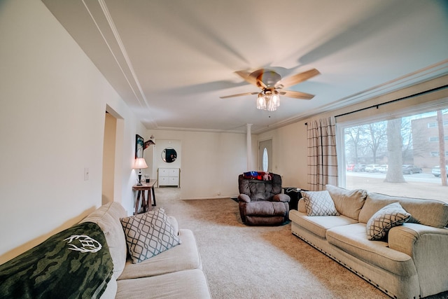 carpeted living room featuring crown molding and ceiling fan