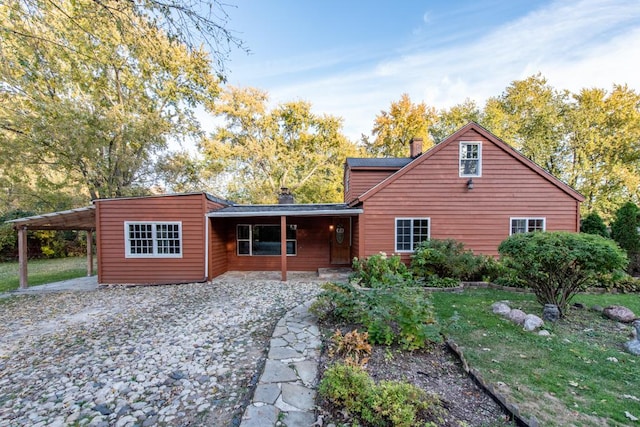 rear view of house featuring a carport