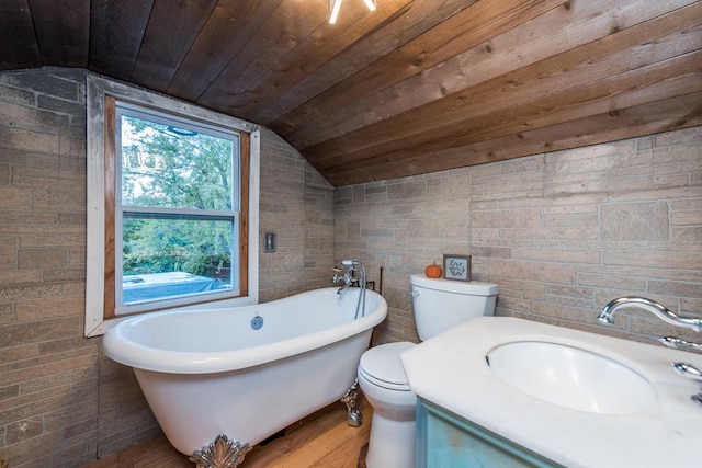 bathroom featuring lofted ceiling, a bathtub, vanity, toilet, and wooden ceiling