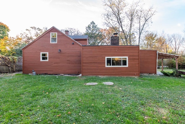 rear view of house featuring a lawn