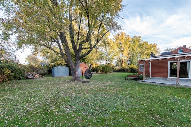 view of yard featuring a patio area and a storage shed