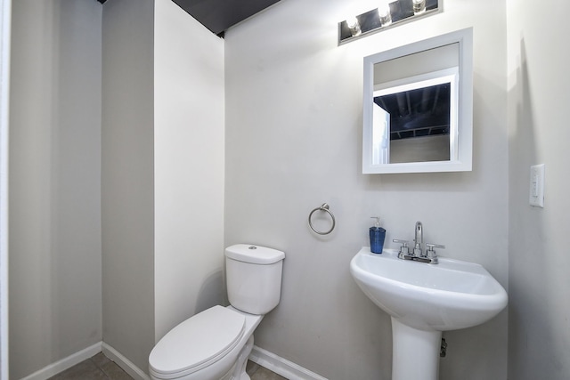 bathroom with tile patterned flooring, sink, and toilet