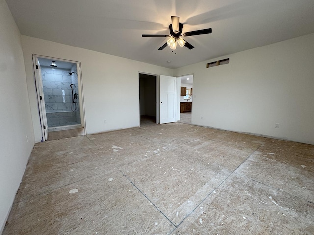 unfurnished bedroom with a walk in closet and connected bathroom