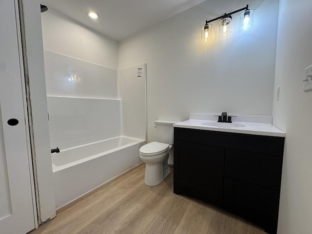 full bathroom featuring shower / bath combination, wood finished floors, toilet, and vanity