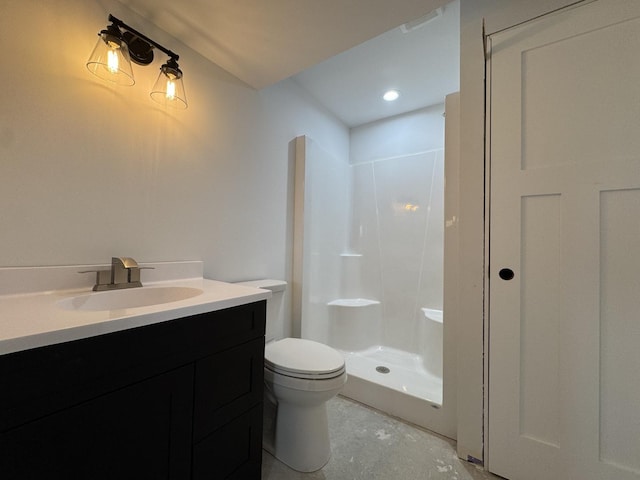 bathroom with toilet, vanity, and a stall shower