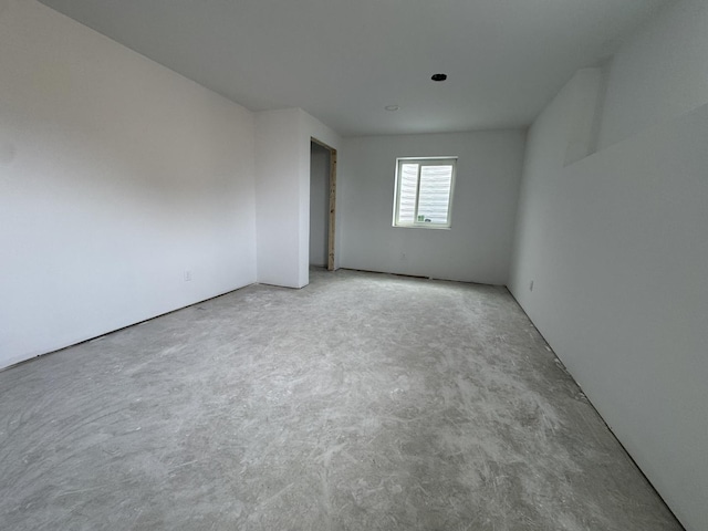 empty room with concrete flooring