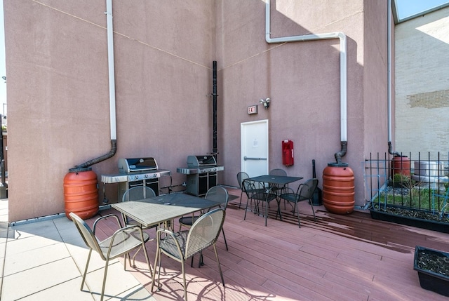 view of patio with grilling area and a deck