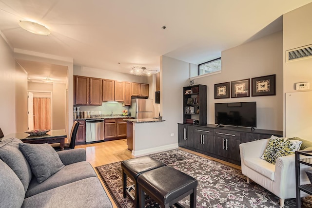 living room with sink and light hardwood / wood-style flooring