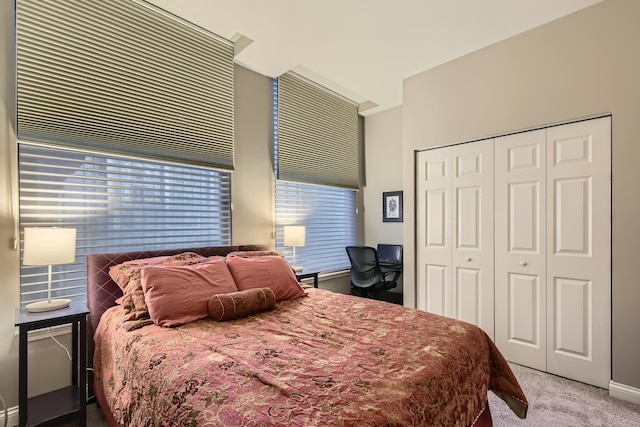 bedroom with light carpet and a closet