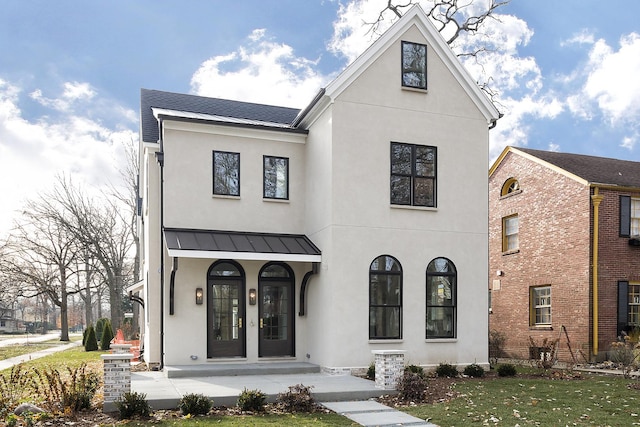 view of front of property with french doors and a front yard