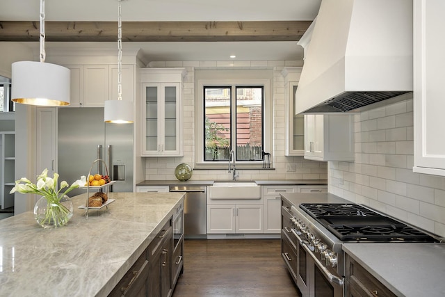 kitchen featuring white cabinetry, high end appliances, custom exhaust hood, and pendant lighting