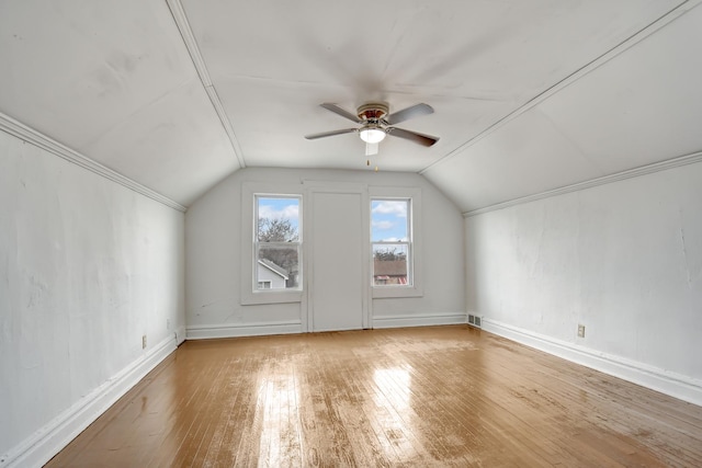 additional living space featuring hardwood / wood-style floors, vaulted ceiling, and ceiling fan