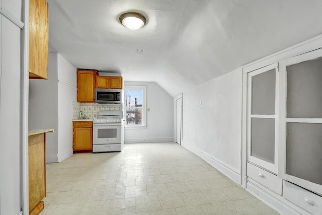 kitchen featuring tasteful backsplash, vaulted ceiling, and white range with gas stovetop