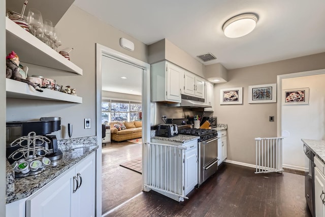 kitchen featuring dark hardwood / wood-style flooring, stainless steel range with gas cooktop, white cabinets, and light stone counters