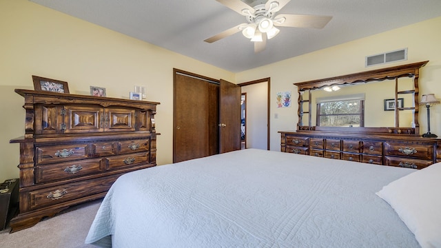 carpeted bedroom featuring a closet and ceiling fan