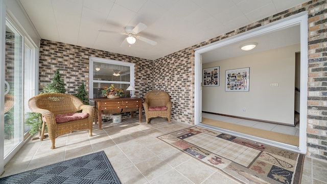 living area with a healthy amount of sunlight and brick wall