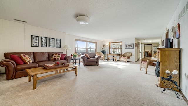 carpeted living room featuring a textured ceiling