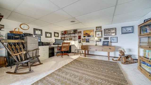 carpeted home office with a drop ceiling