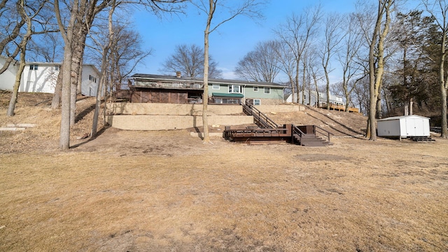 view of yard featuring a storage shed and a wooden deck