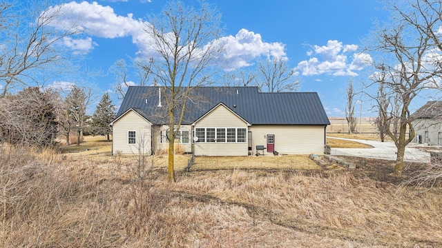 back of property featuring metal roof