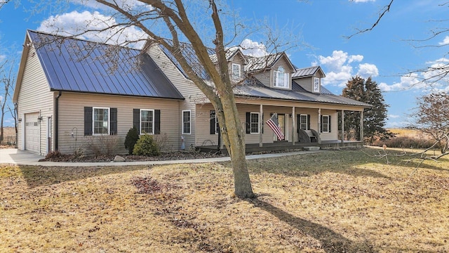 cape cod house with covered porch, metal roof, a front lawn, and an attached garage