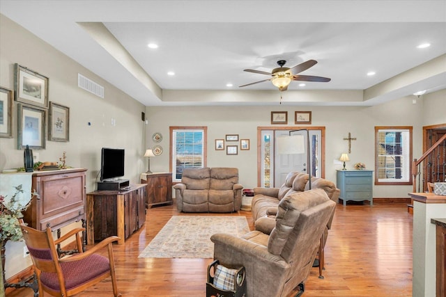 living area with plenty of natural light, light wood-type flooring, and visible vents