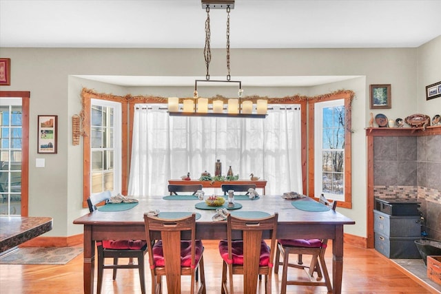 dining space featuring plenty of natural light, baseboards, and wood finished floors